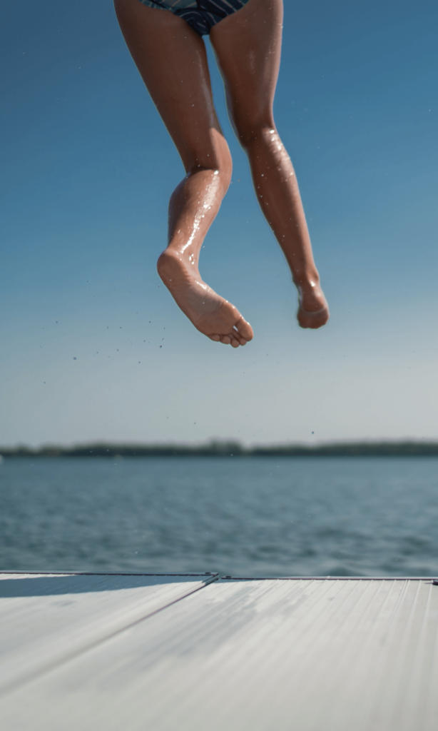 Girls jumping off FLOE dock into the lake