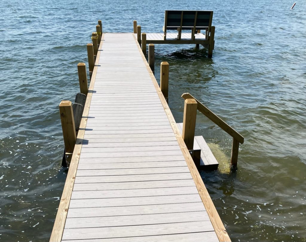 Composite decking on a wood pier with a bench