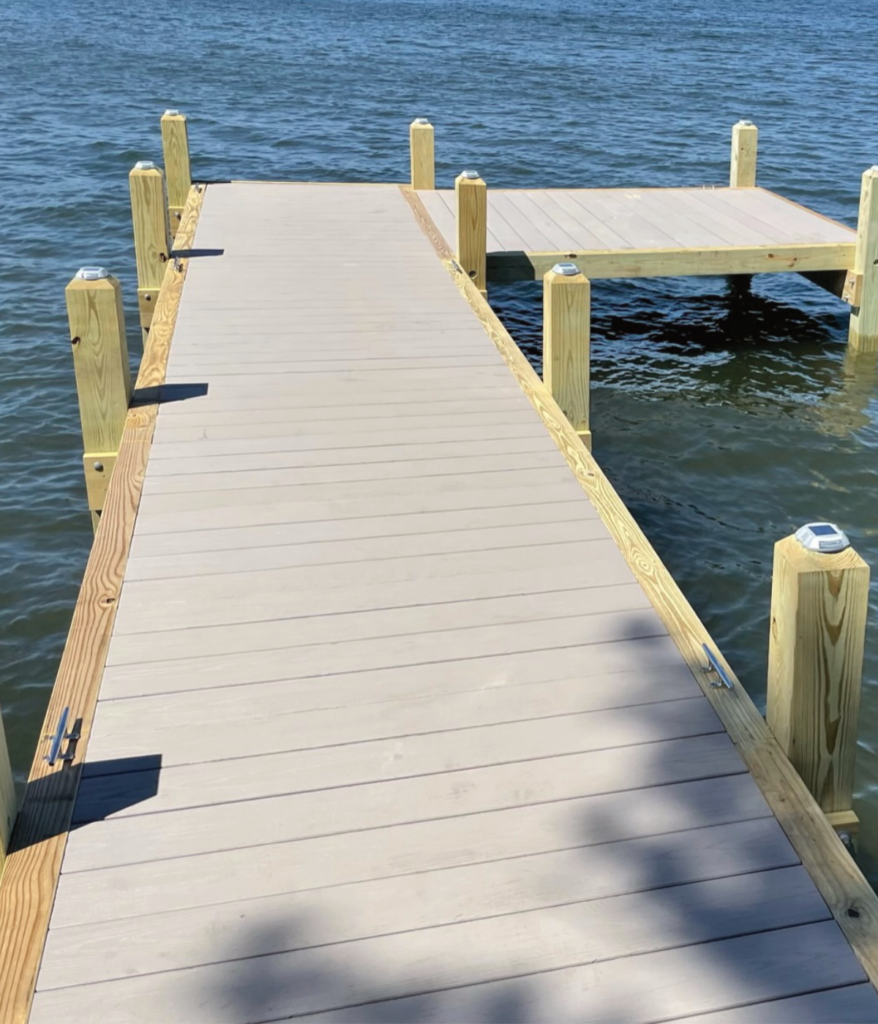 Solar powered lights on a wood pier with composite decking tops