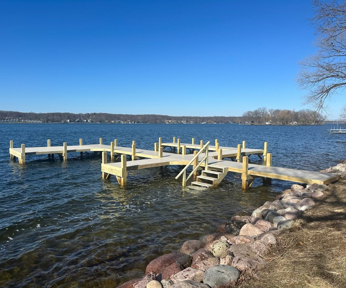 Custom dock layouts featuring a multi-boat docking system with L-shape and U-shape configurations on Pewaukee Lake, Wisconsin.