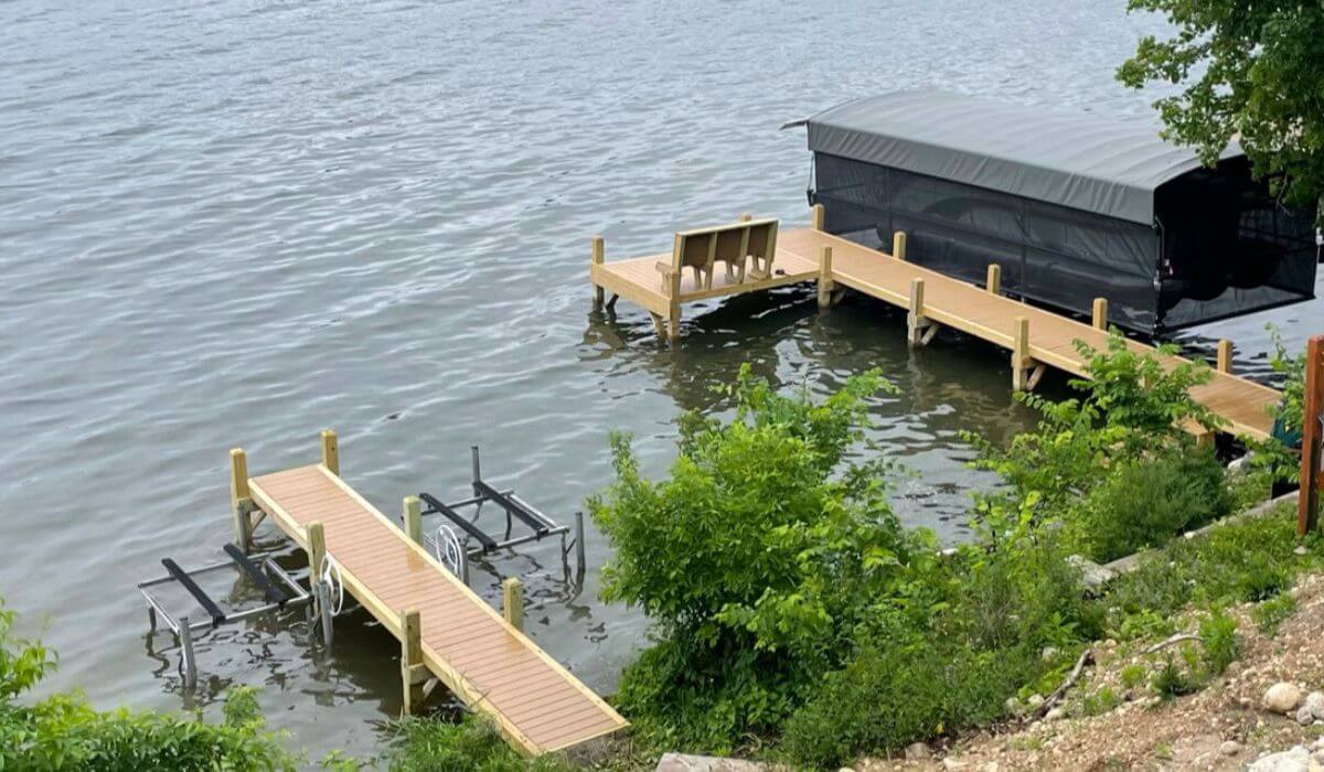 Two docks featuring a jet ski dock and a dock for the pontoon boat and bench.