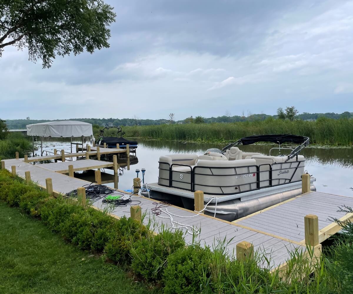 Custom wood dock with multiple boat slips and integrated shoreline walkway.