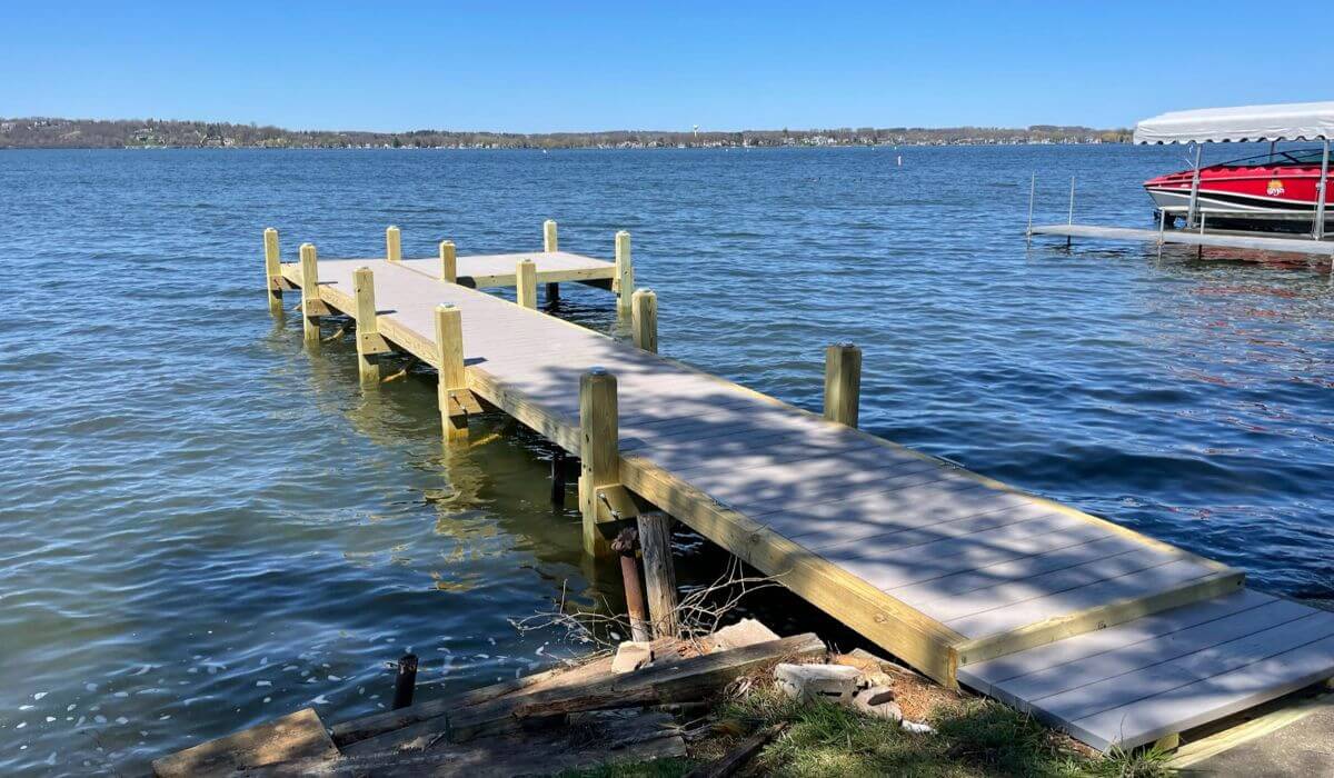 Composite wood dock in an L shape on Pewaukee Lake, Waukesha County Wisconsin.